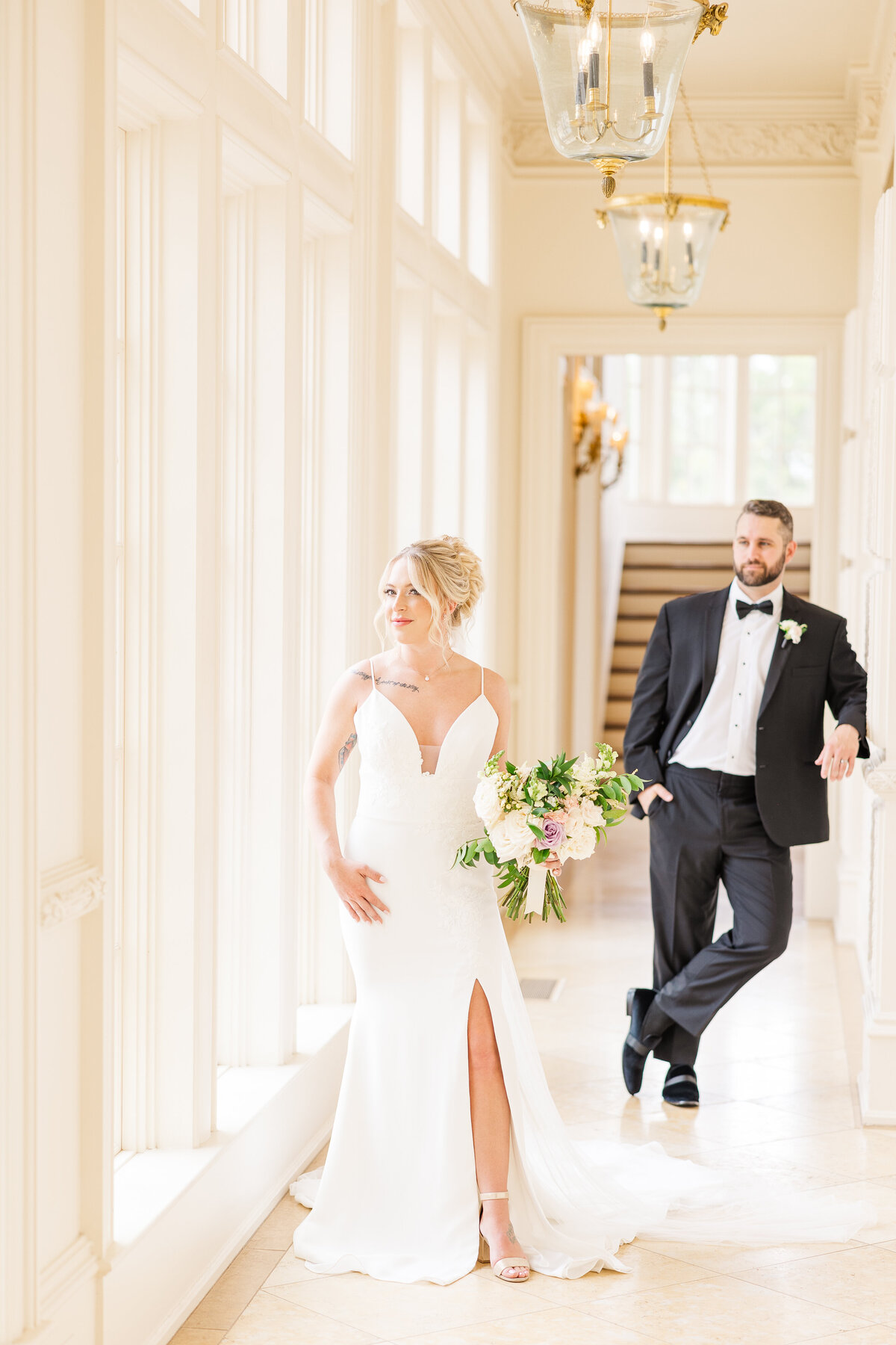 bride-and-groom-pose-in-beautifully-lit-hallway