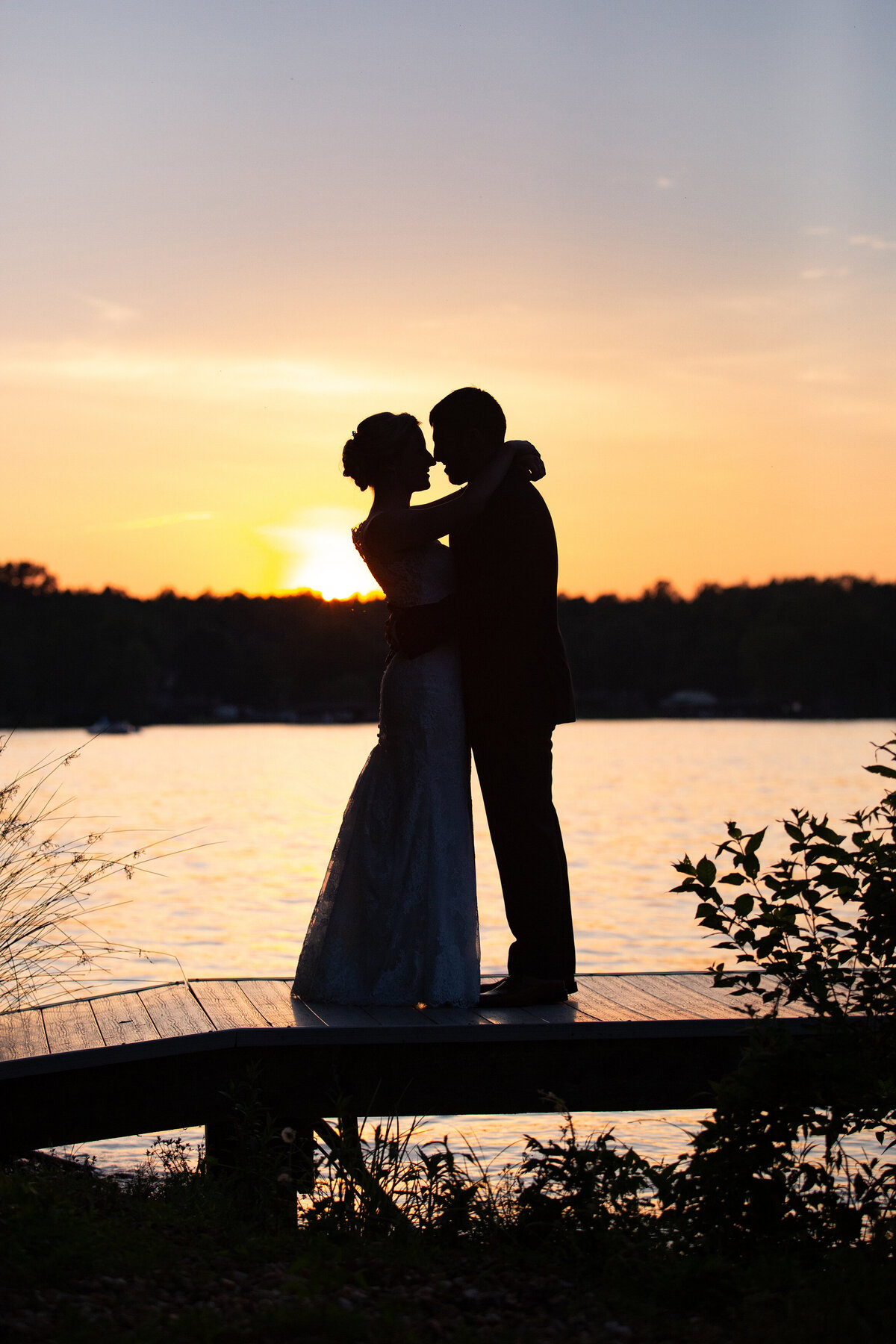 Sunset silhouette of the bride and groom at Lake Anna, Virginia