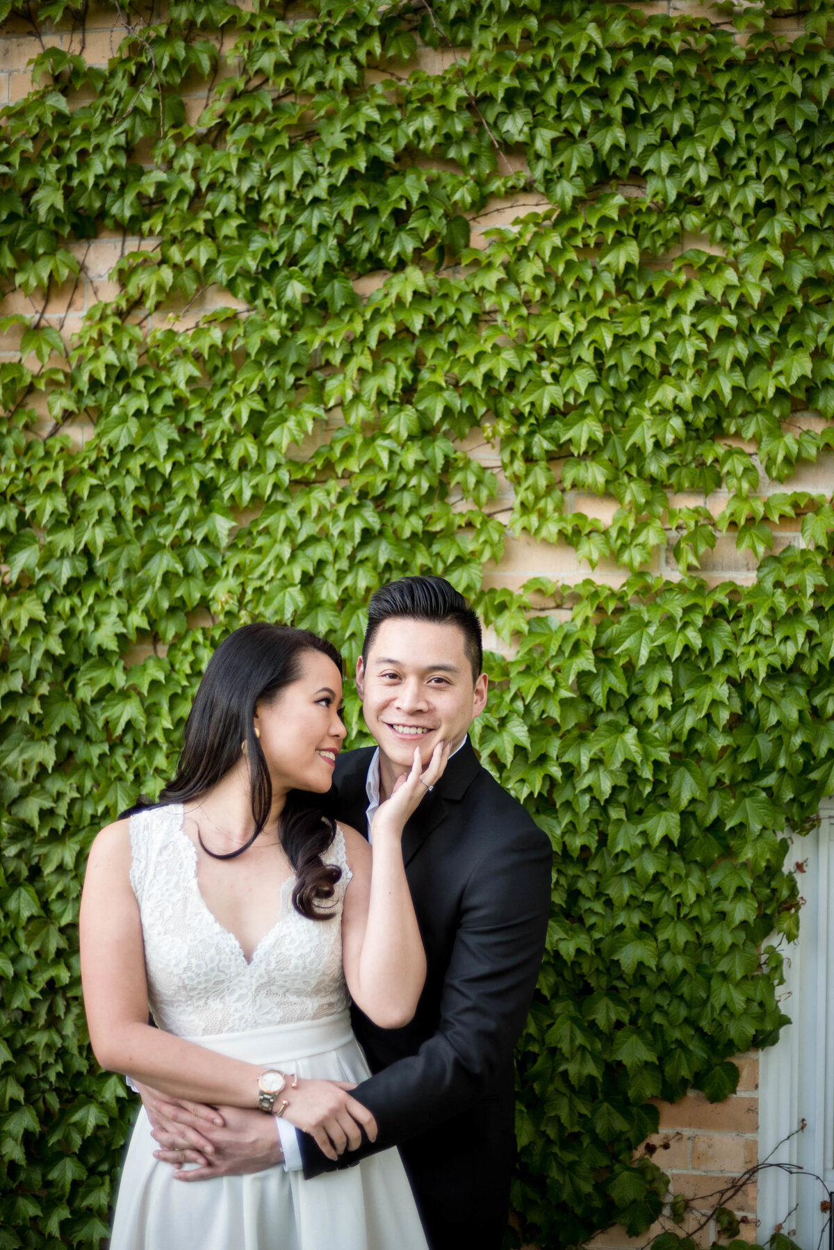 couple in front of ivy wall
