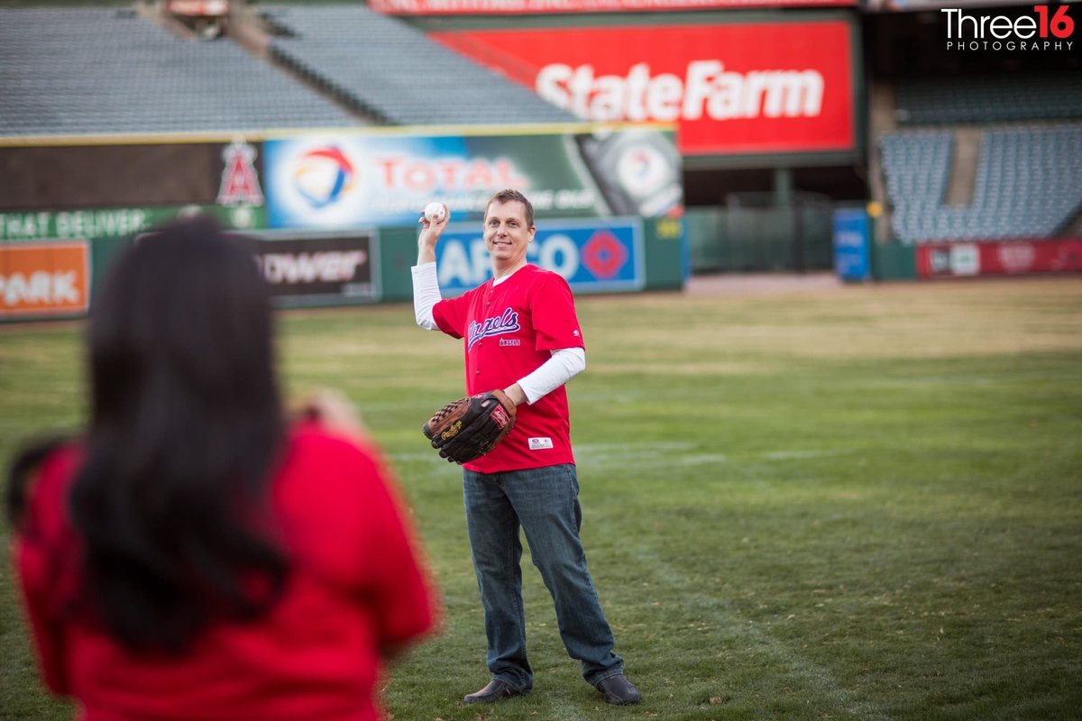 Groom-to-be sets to throw the baseball to his fiance