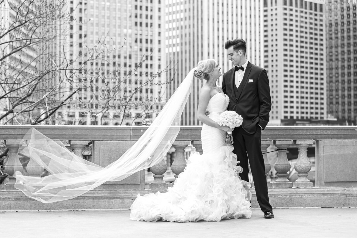 A bride’s veil blows in the wind outside of the Wrigley building in Chicago, IL