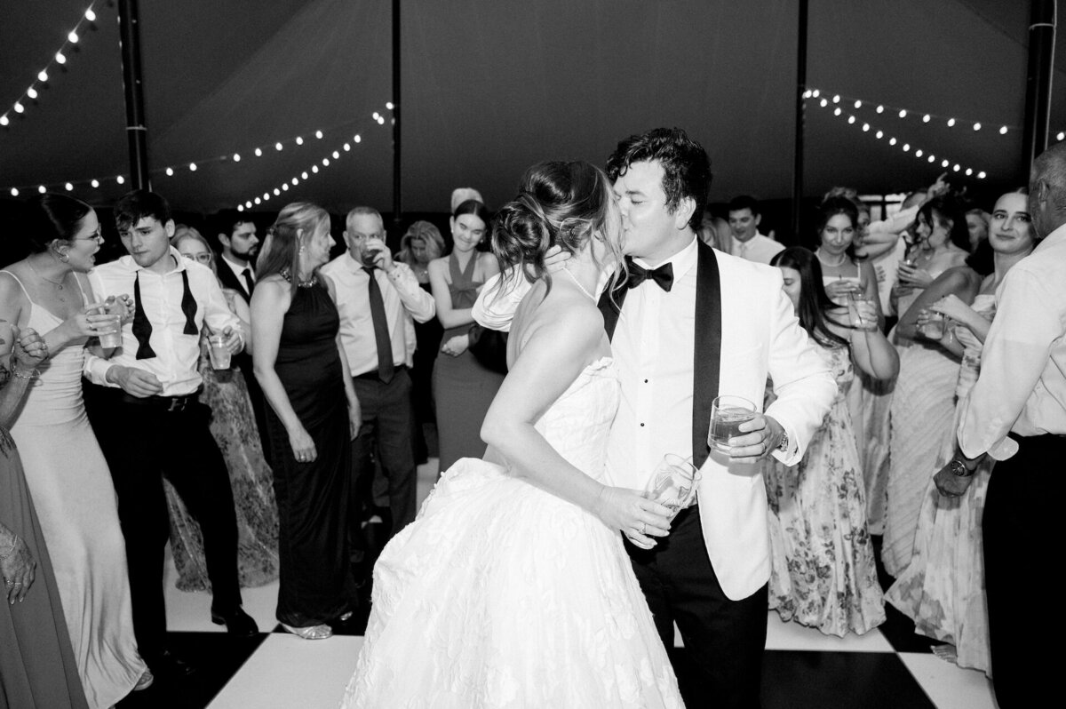 bride and groom kissing during their wedding reception