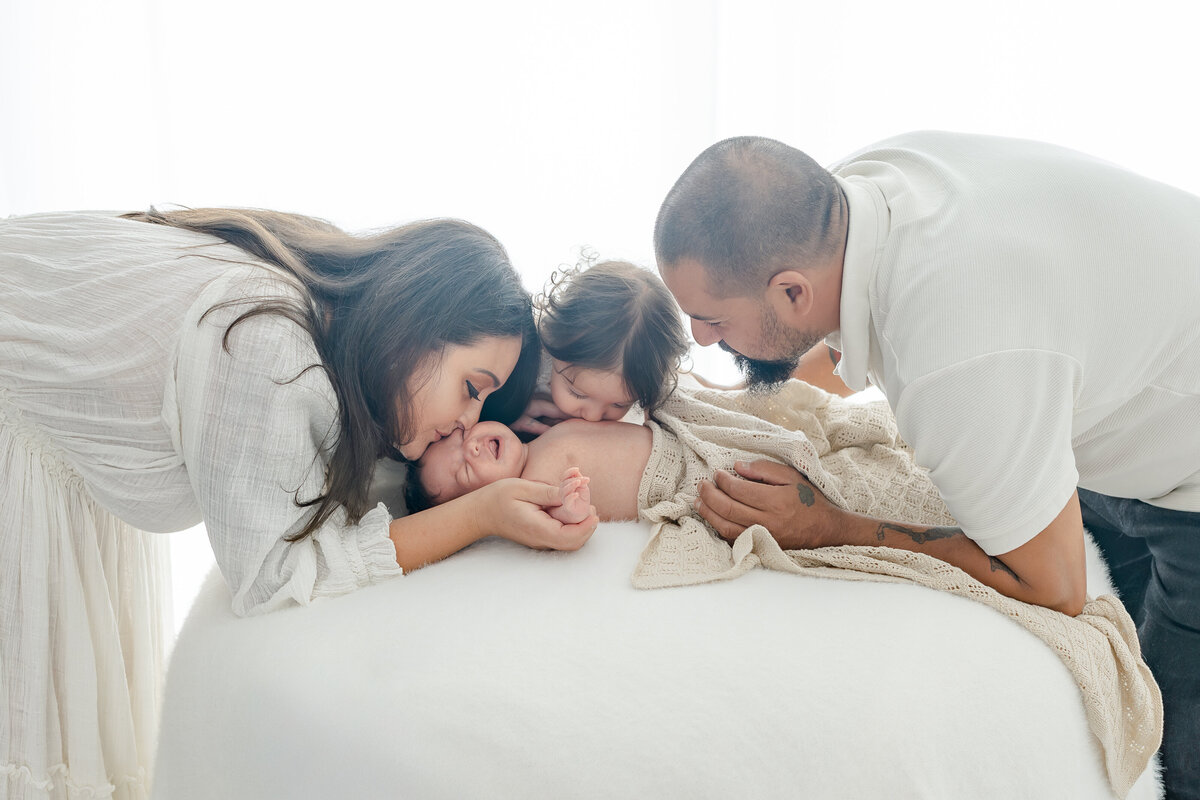 Family holding newborn during natural light Barrie newborn photography session 