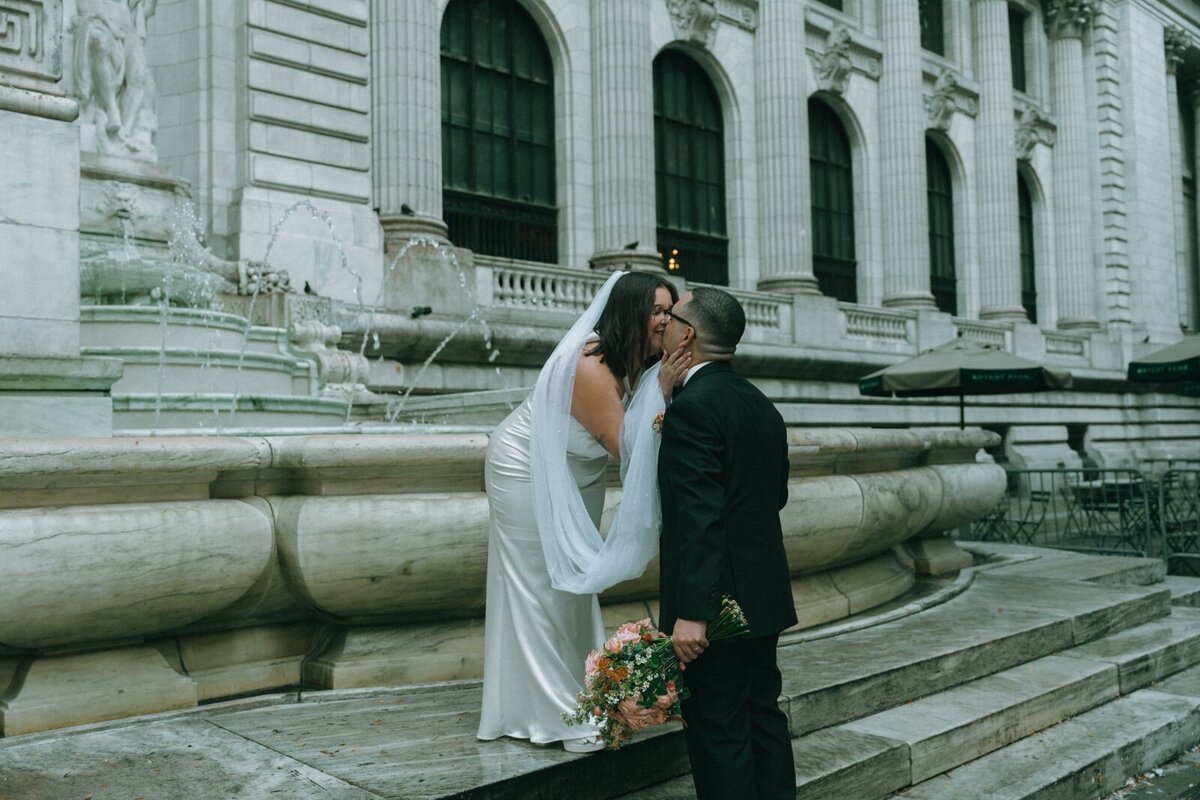 bride and groom kiss after NY public library elopement shot by Elsie Goodman Photography | NYC Elopement Packages