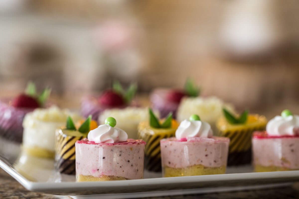 Close-up of pink mousse cakes with whipped topping