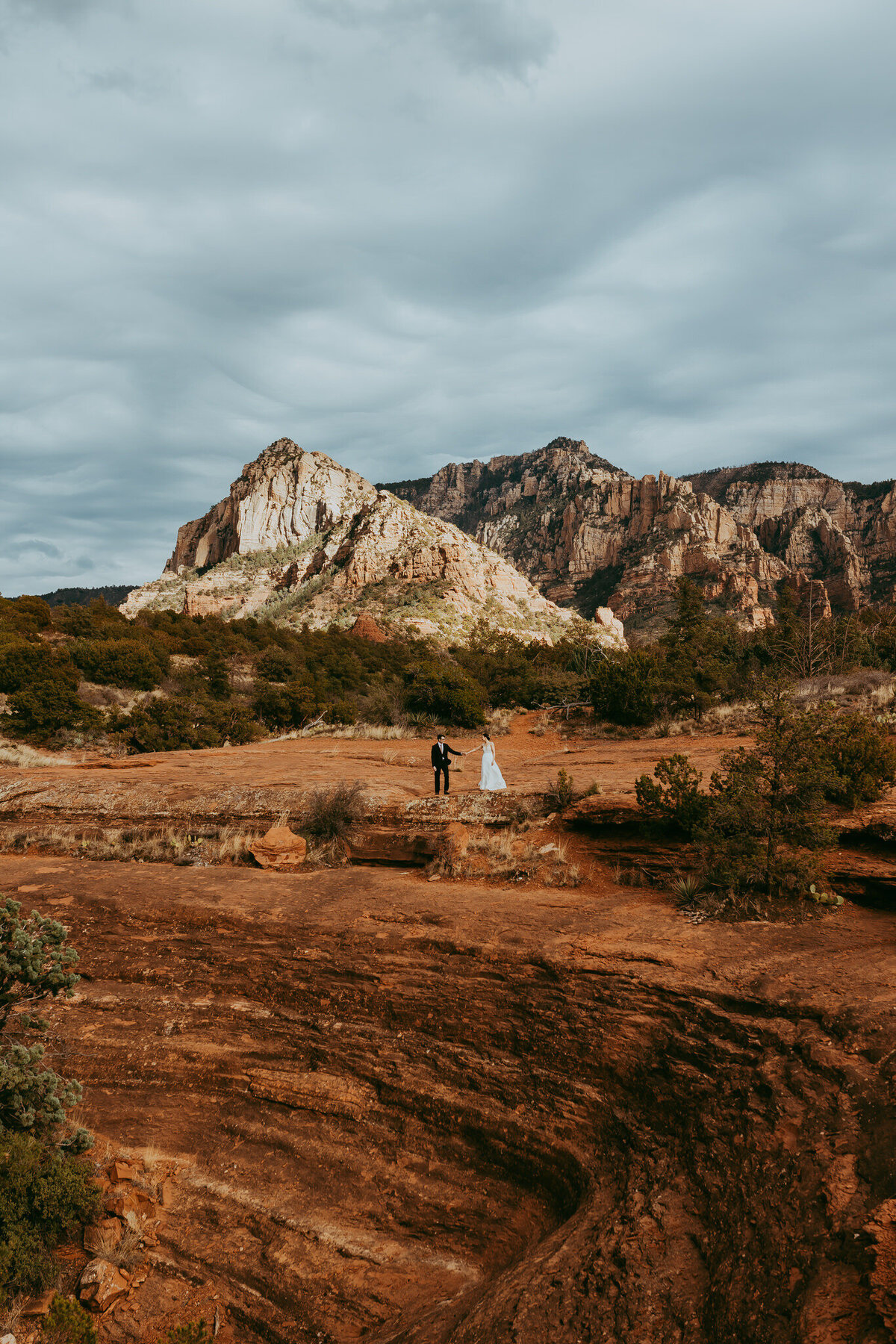 sedona landscape with bridal couple holding hands