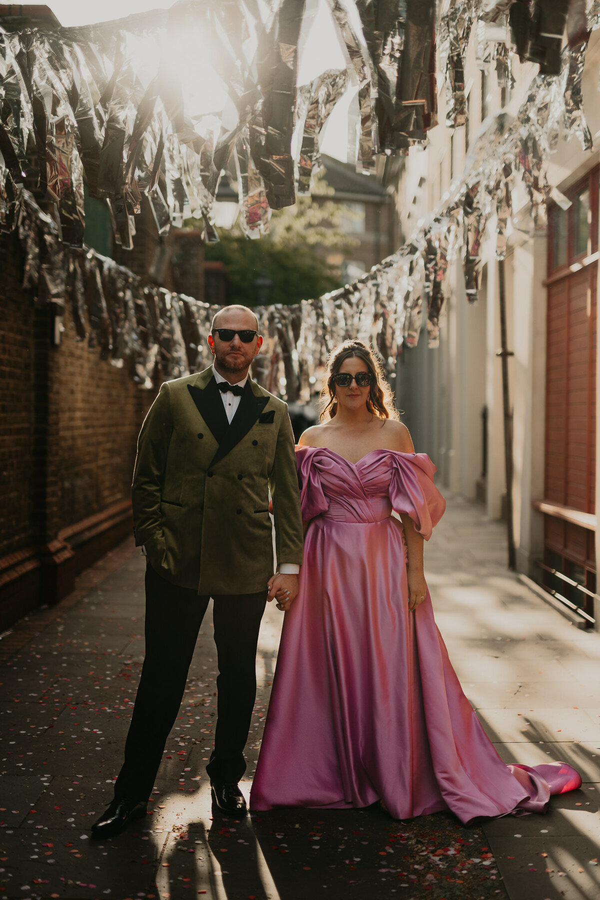 Bride and Groom pose outside Wilton's Music Hall. 