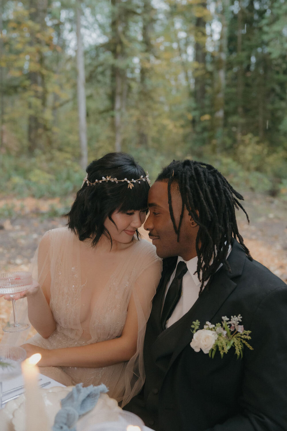 Bride and groom sharing a romantic moment at their wedding table