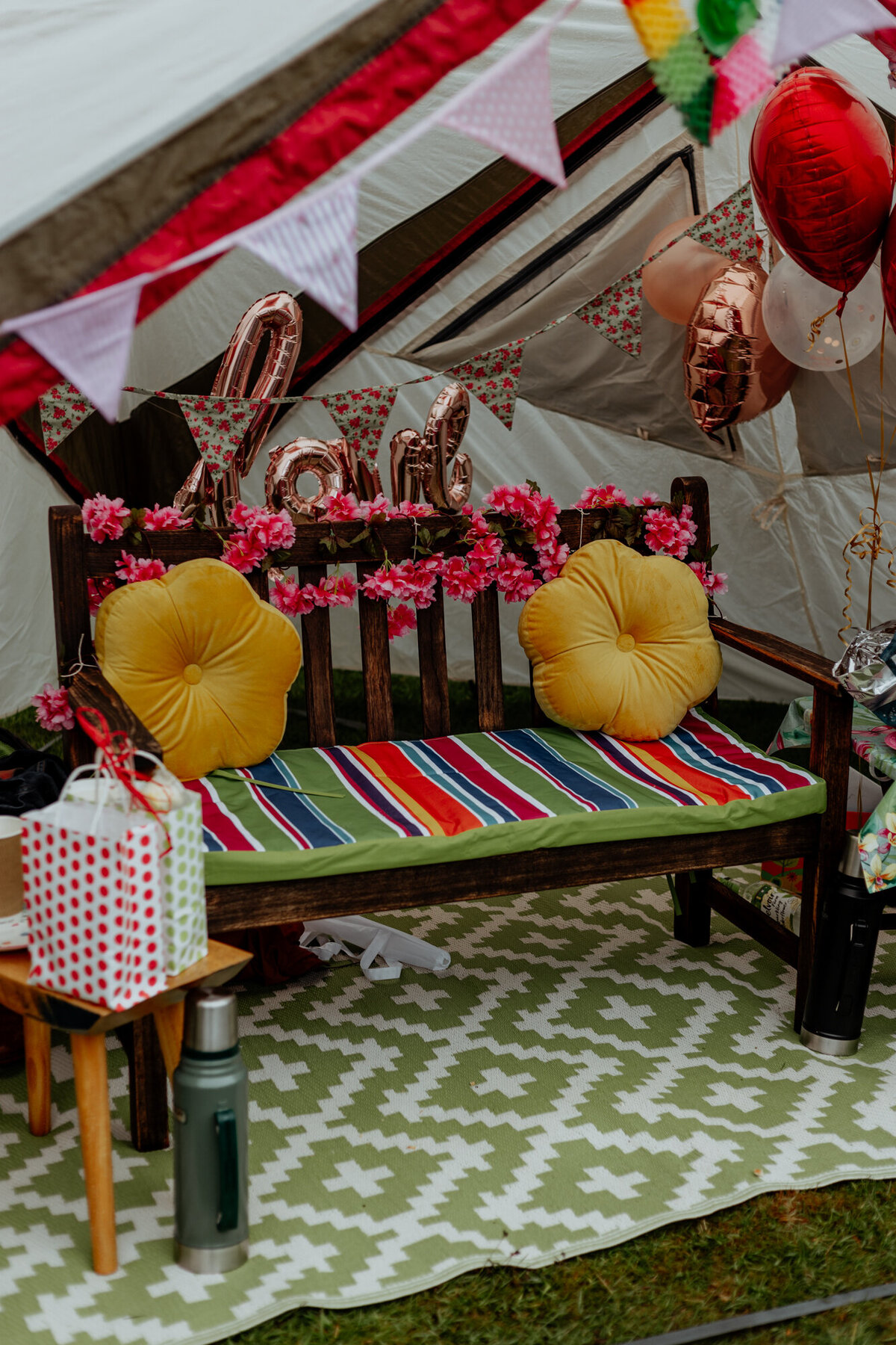 wedding reception bench with cushions in tent