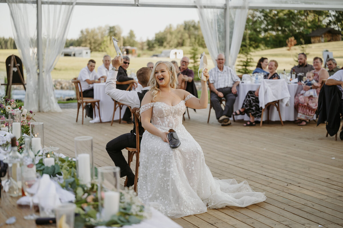 couple playing shoe game at alberta wedding