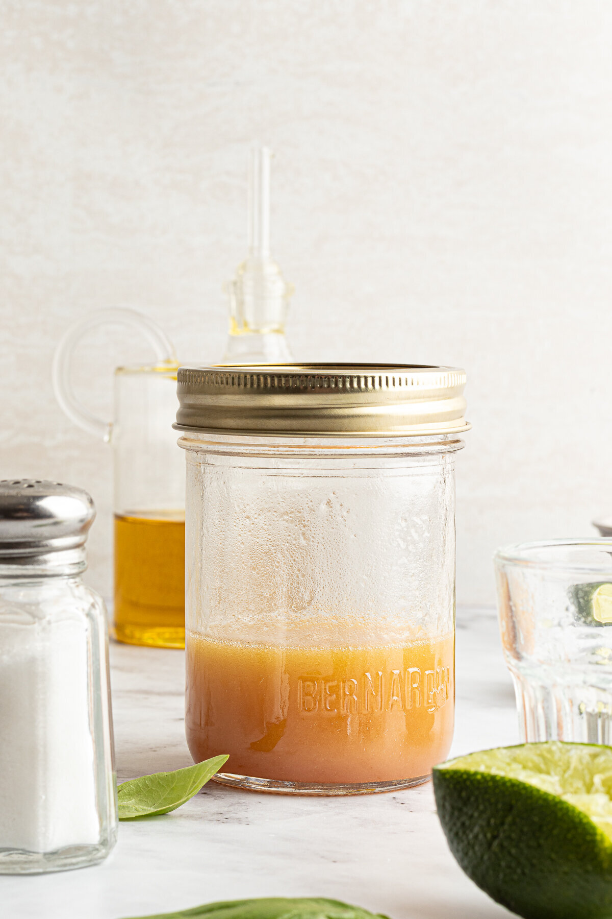 a mason jar with a honey colored sauce in it