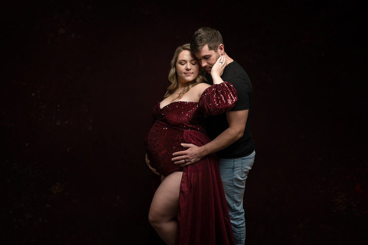 Expecting couple posed during their studio maternity session in Minnesota.