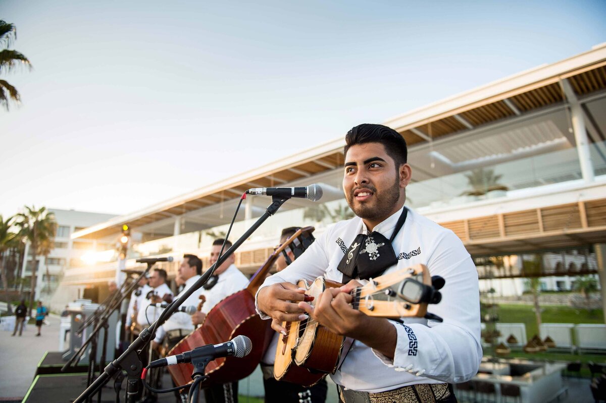 A mariachi sings with guitar poolside in front of Gabi at Paradisus inLos Cabos for welcome reception entertainment