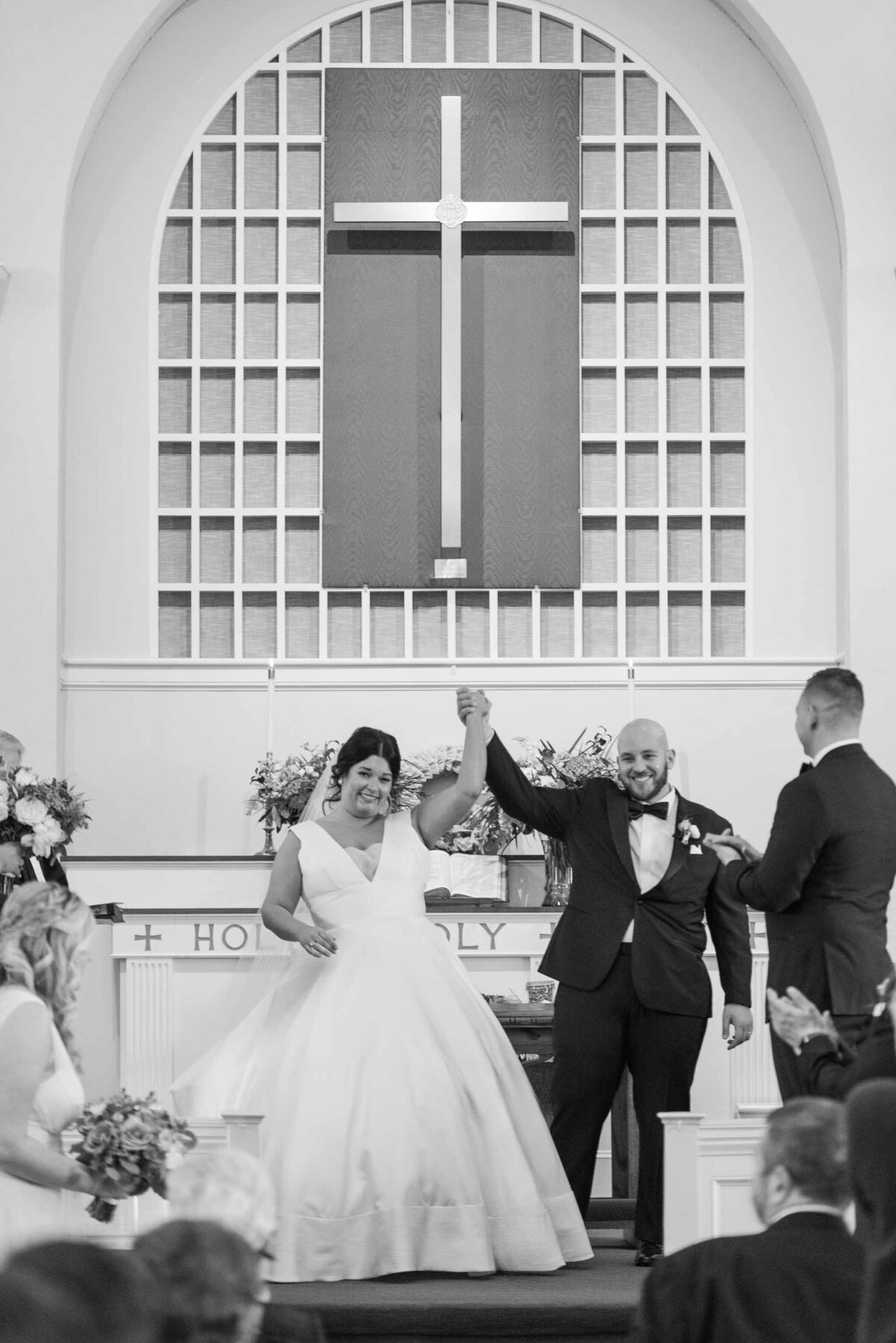 couple cheering after wedding ceremony