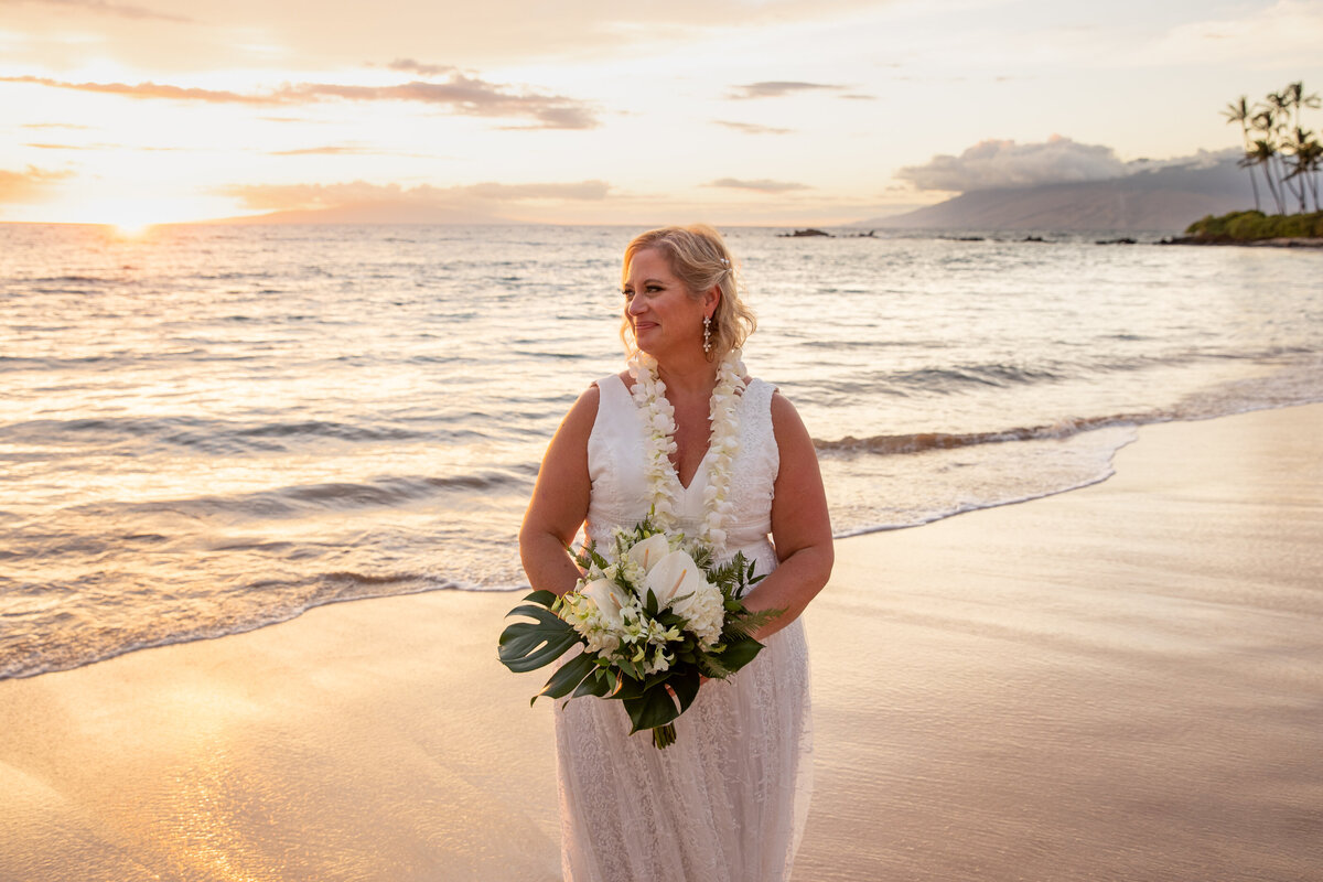 Maui Wedding Photographer captures bride holding white bouquet at sunset