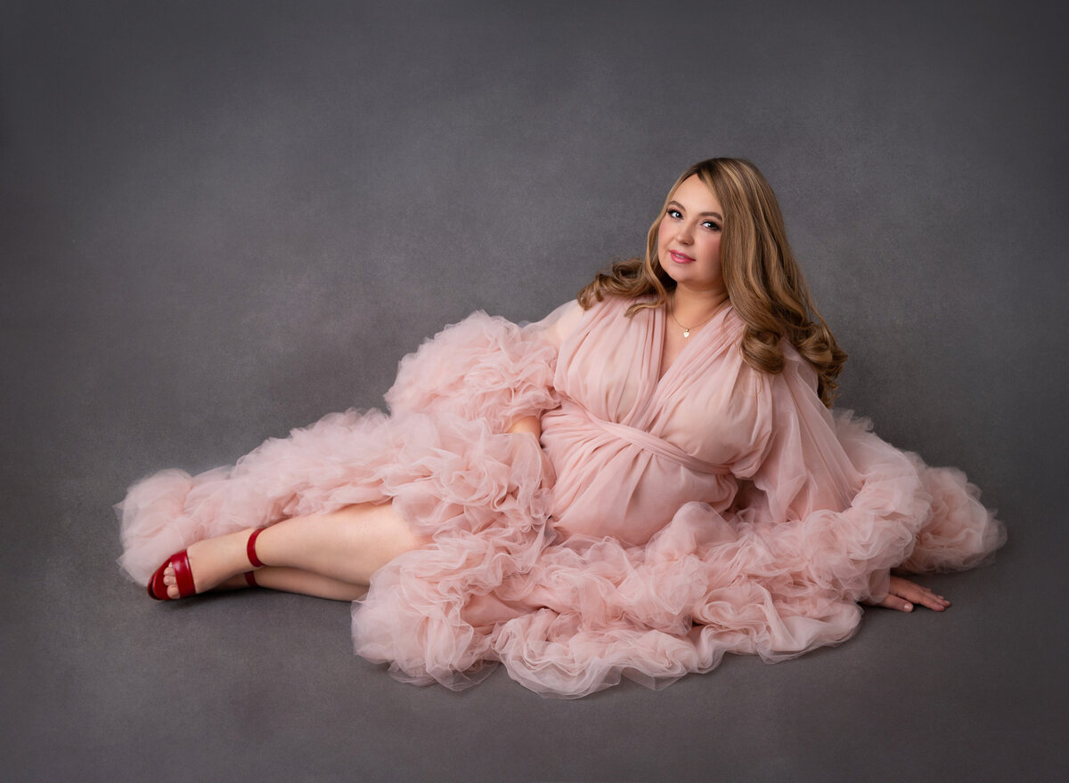 Maternity pictures done By Rochel Konik photography  mom wearing pink puffy gown