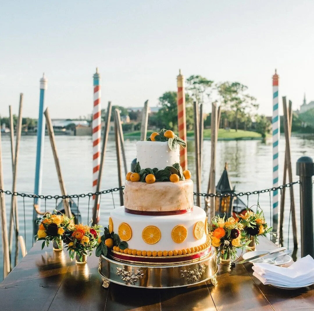 Disney's EPCOT Italy Pavilion reception site with citrus inspired decor and wedding cake