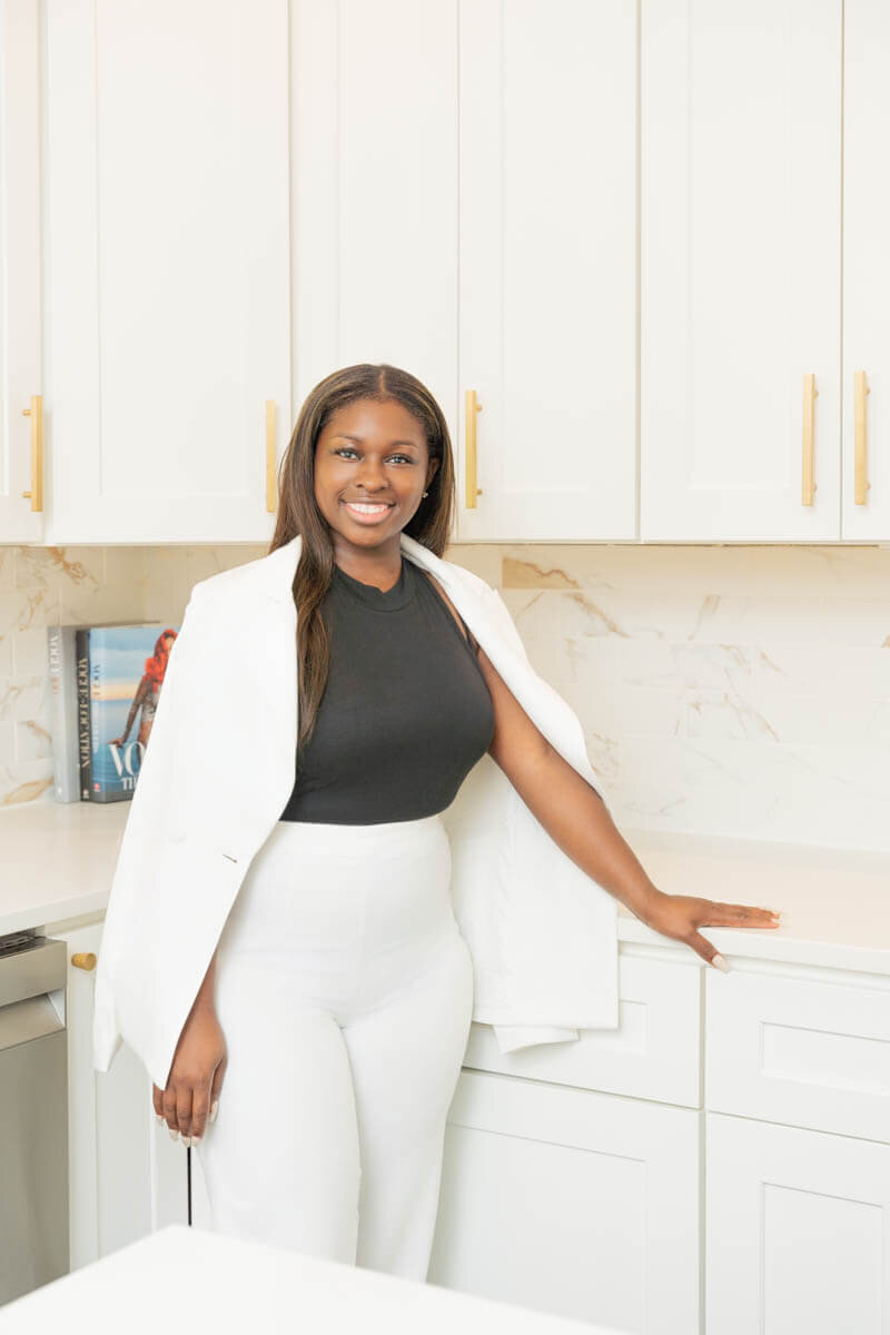 realtor in a white suit posing for olya photography branding photoshoot