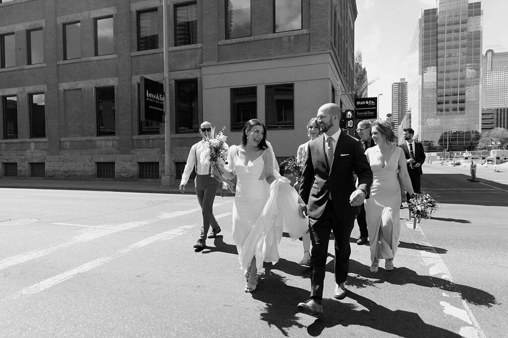 Wedding party walking  downtown, by Court Amber Photography, joyful and adventurous wedding photographer in Calgary, Alberta. Featured on the Bronte Bride Vendor Guide.