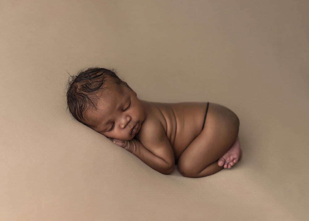 NEWBORN_BABYBOYAFRICANBABYSLEEPINGBROWN