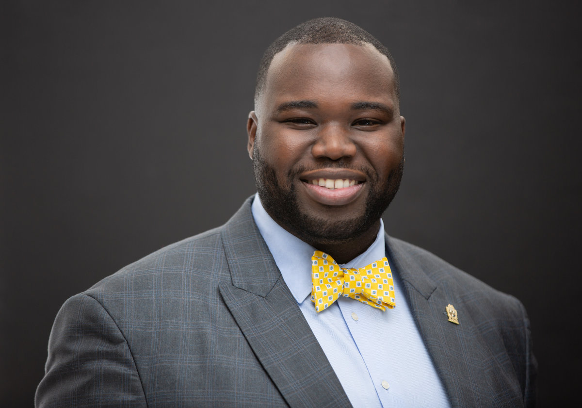 An African American black investor in a grey suit poses for a professional headshot photo for Janel Lee Photography studios in Cincinnati Ohio