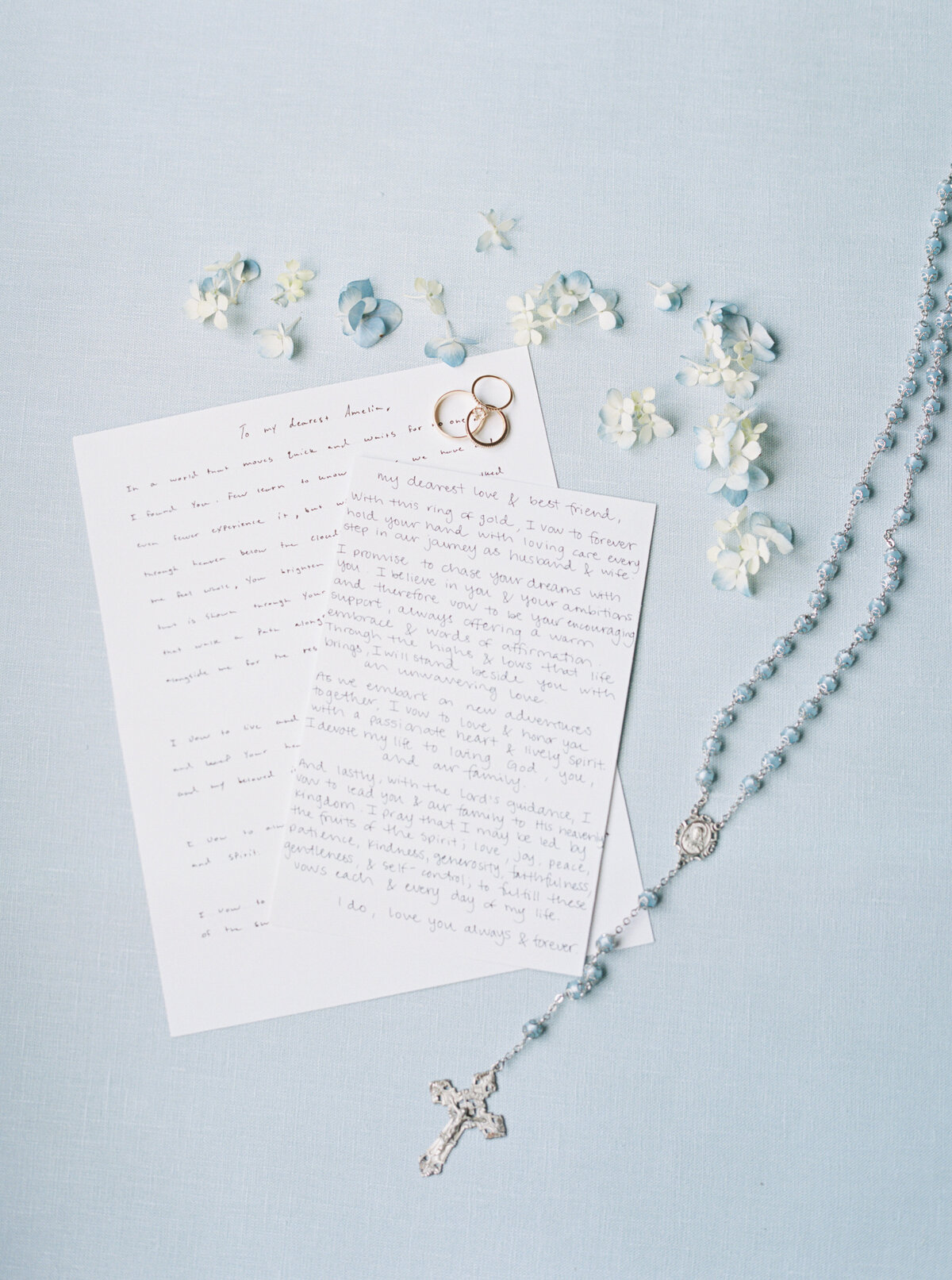 A heartfelt capture of the bride and groom’s vows set against a soft blue background, beautifully documented on film by Morgan Alysse, Louisiana film photographer.
