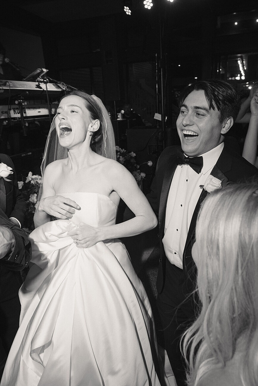 bride and groom singing at wedding reception