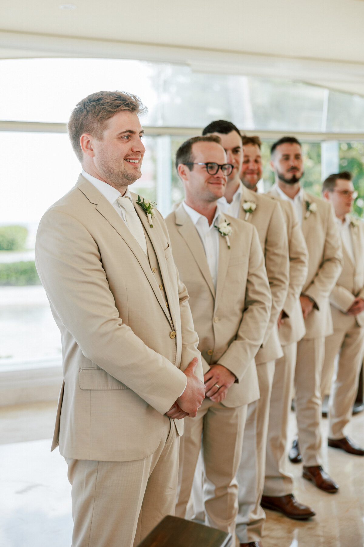 Groom and groomsmen wait at Cancun wedding ceremony, photo by Philadelphia wedding photographer.