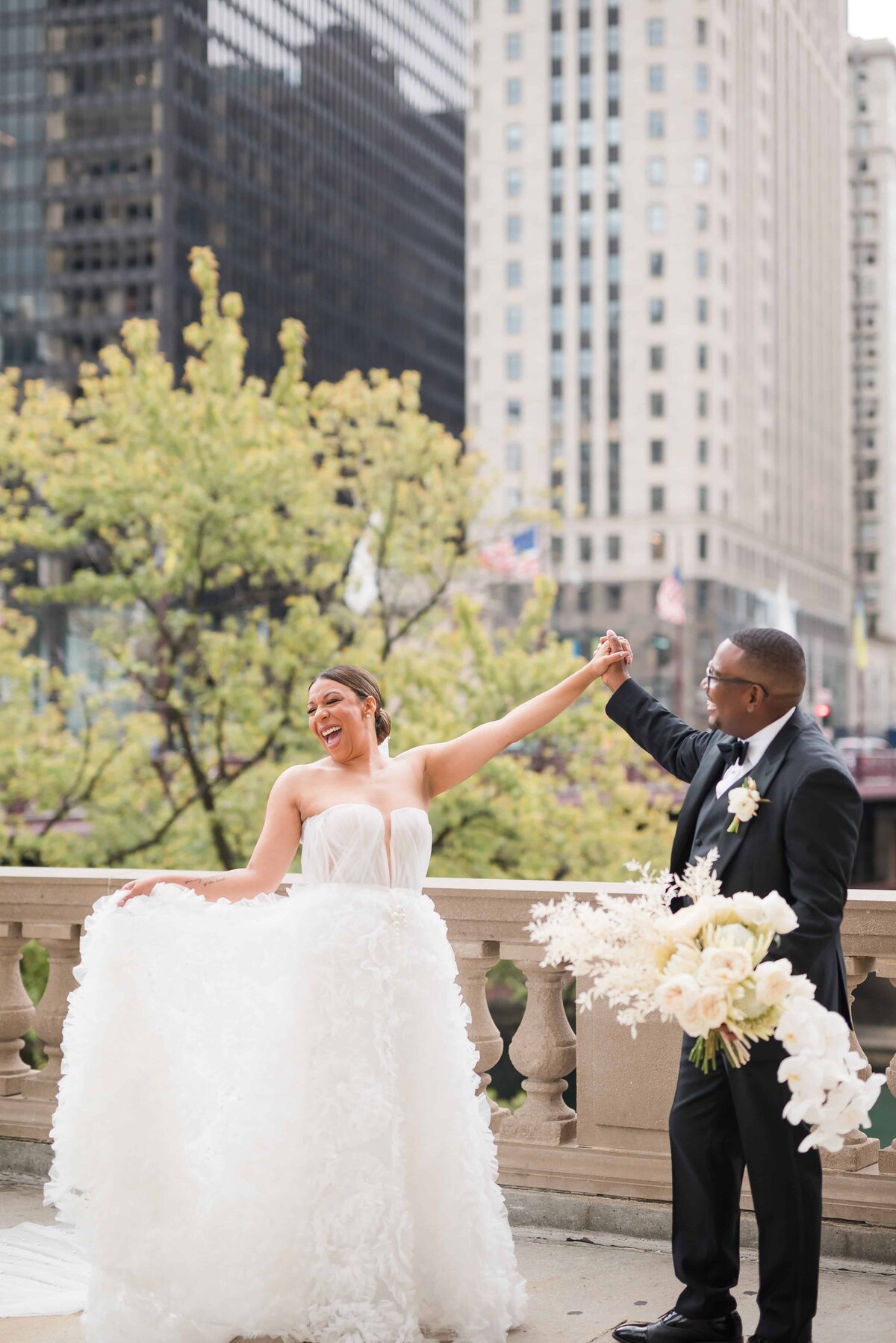 Bride and groom laughing and twirling in Chicago