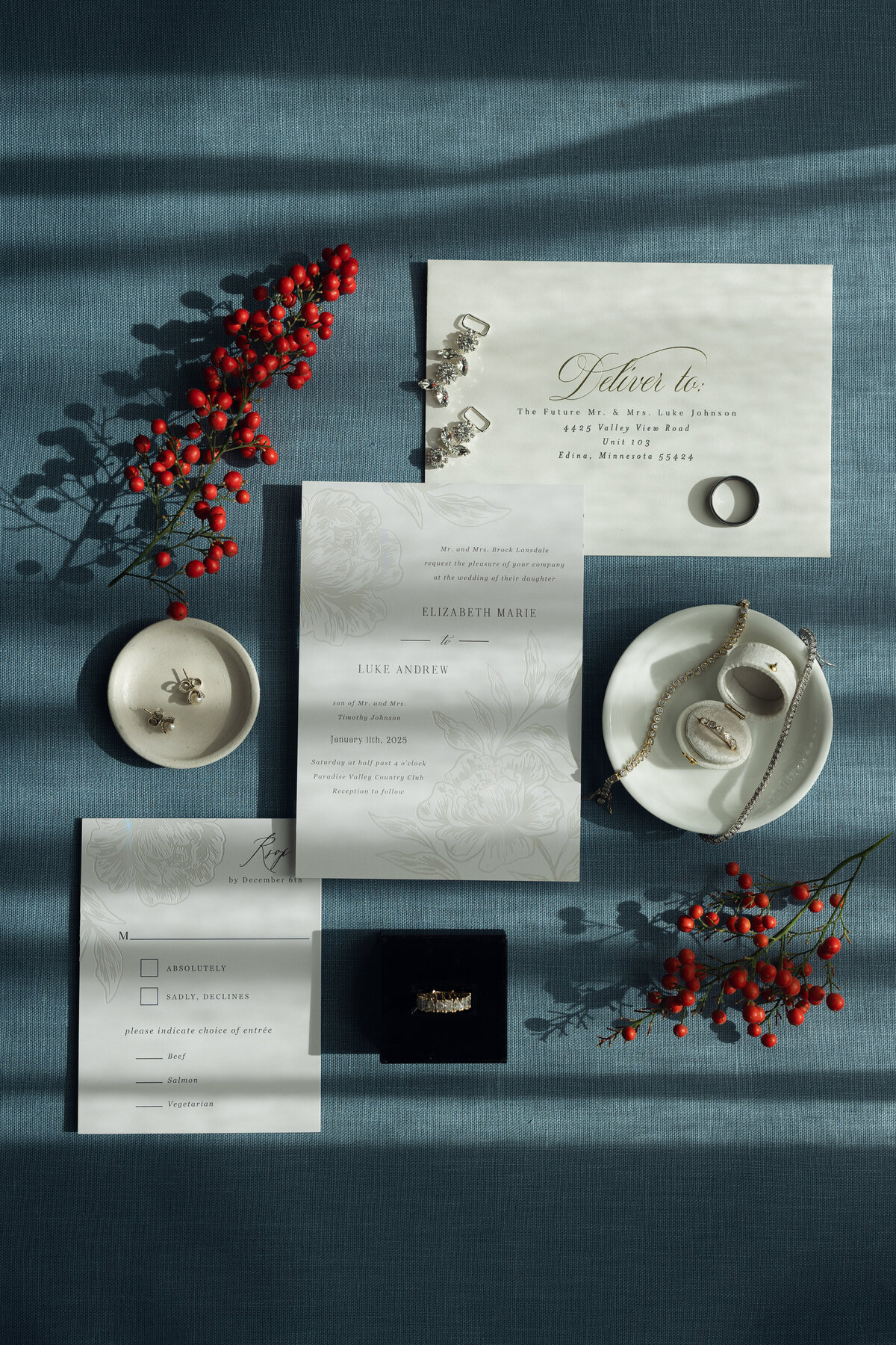 Wedding flatlay details with invitation suite, flowers and jewelry