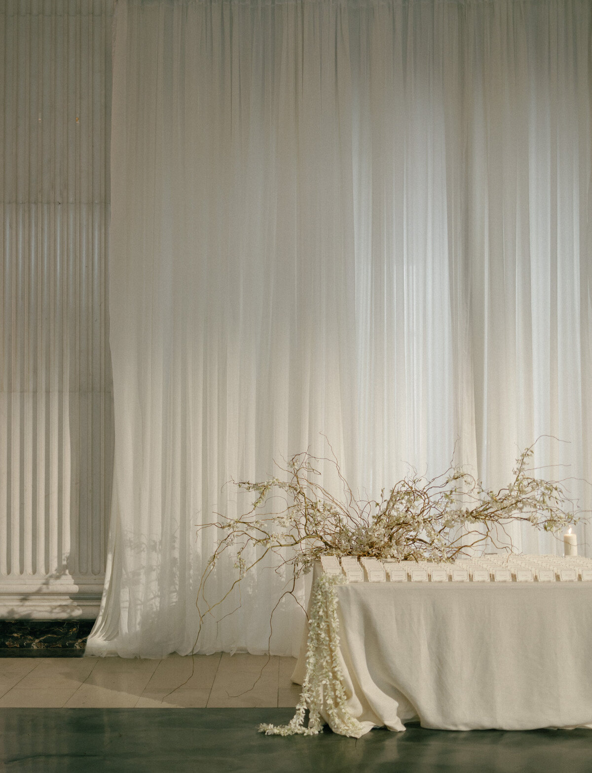Ethereal, quiet orchid floral install for escort card table at a State Savings Bank wedding in Michigan
