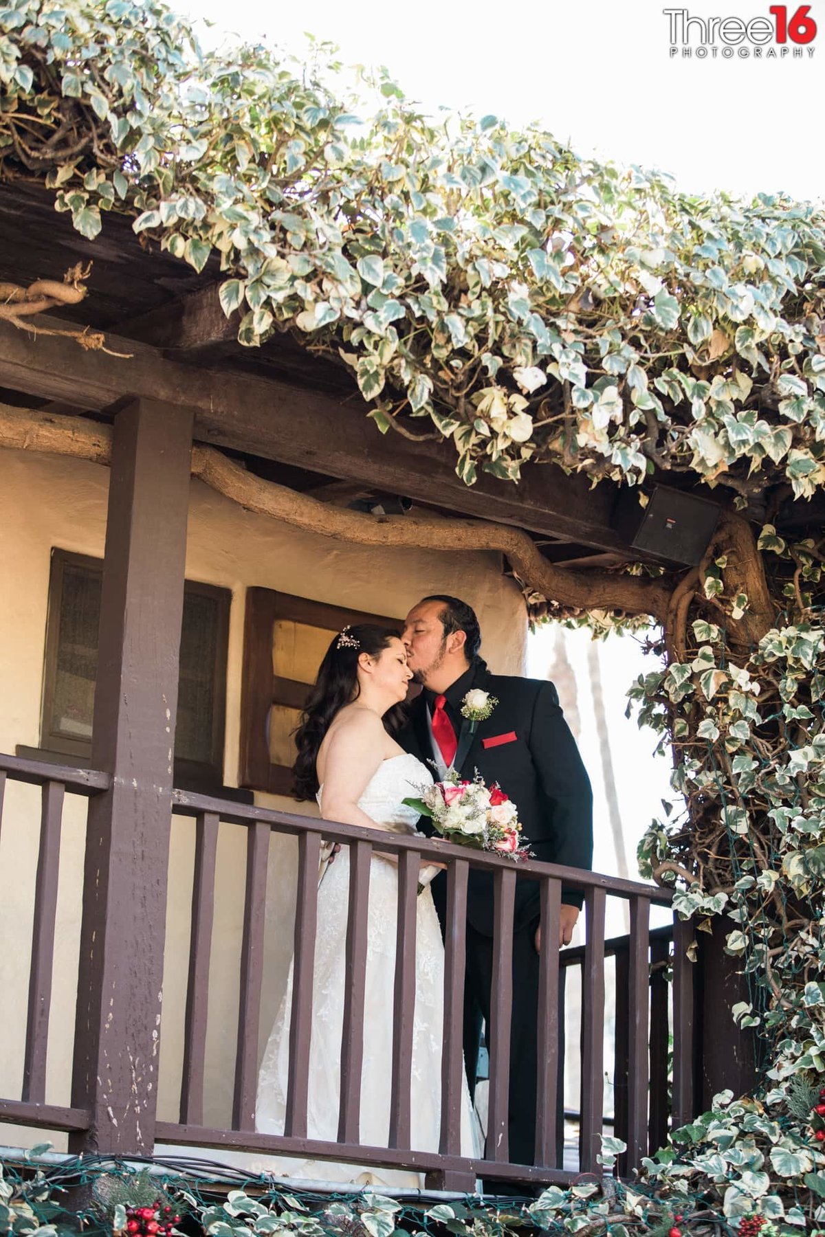 Groom kisses his Bride on her forehead