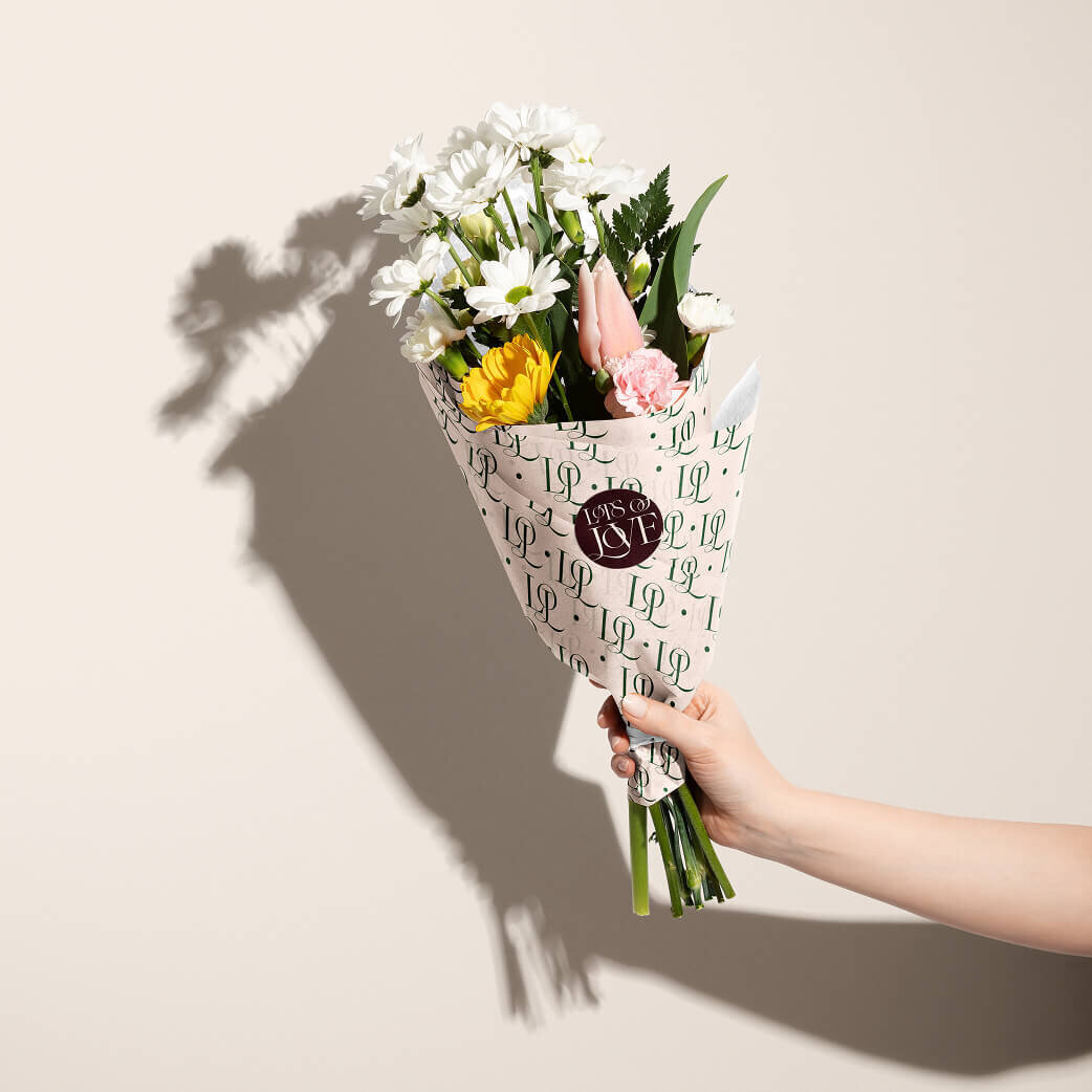 Premium wedding floral packaging featuring a sleek black box with gold embossed floral designs, perfect for exclusive bridal bouquets.
