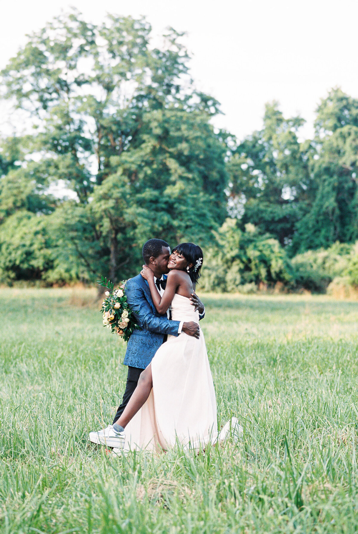 A bride and groom on a field after their wedding.