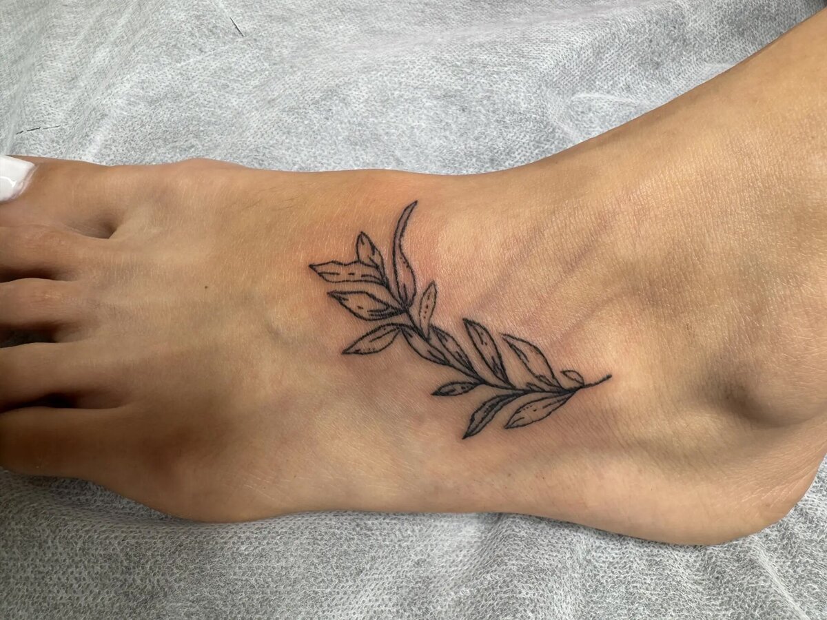 leaves tattoo on foot