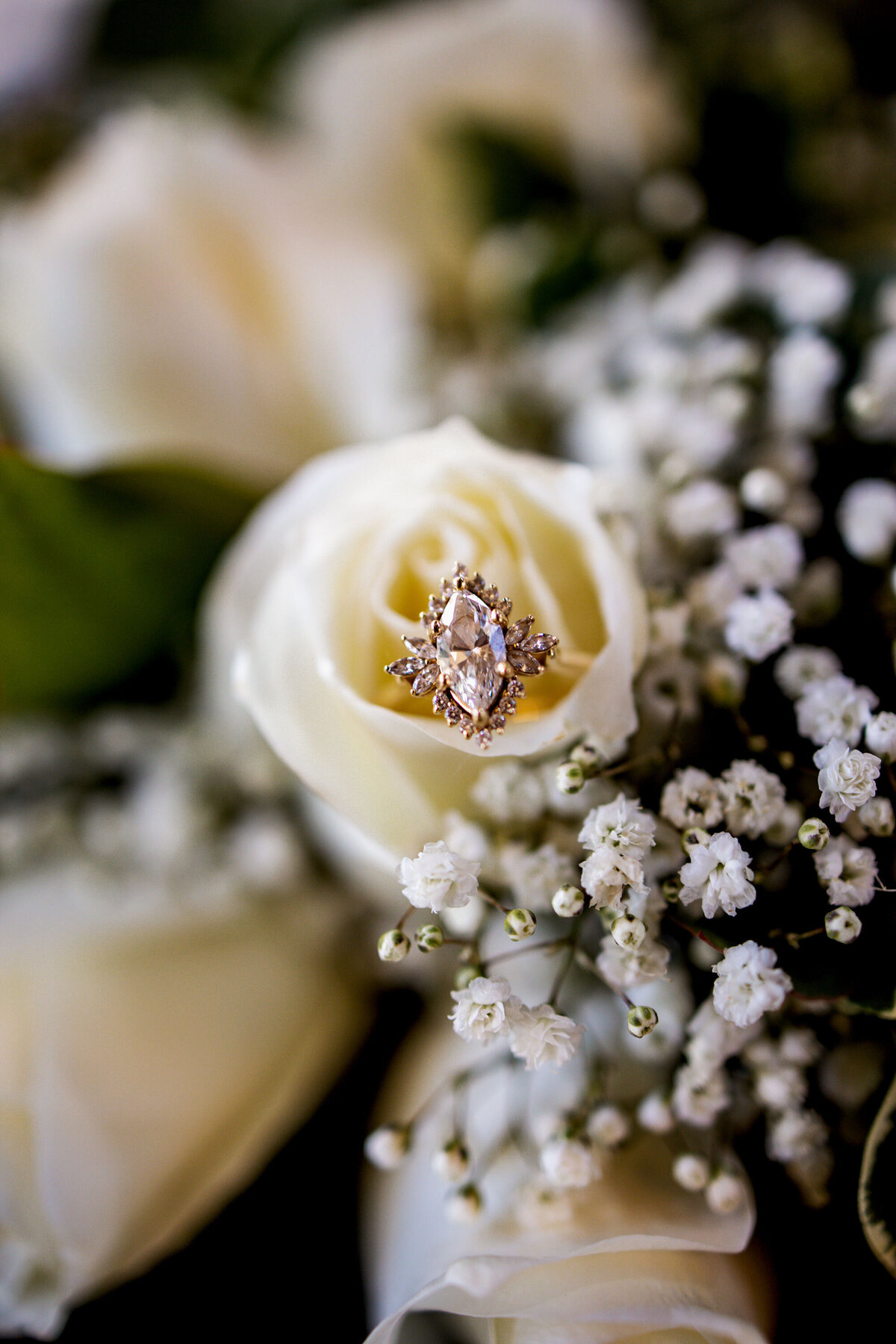 a marquis cut diamond ring with a rose