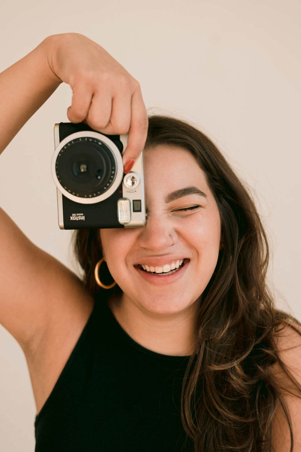 woman holding a camera up over one eye