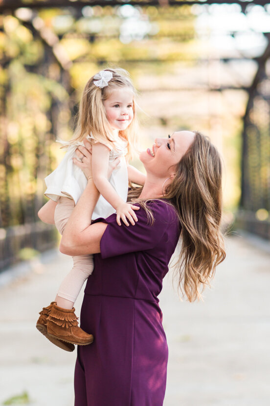 mother-holding-up-daughter-at--sweetwater-river-bridge-san-diego