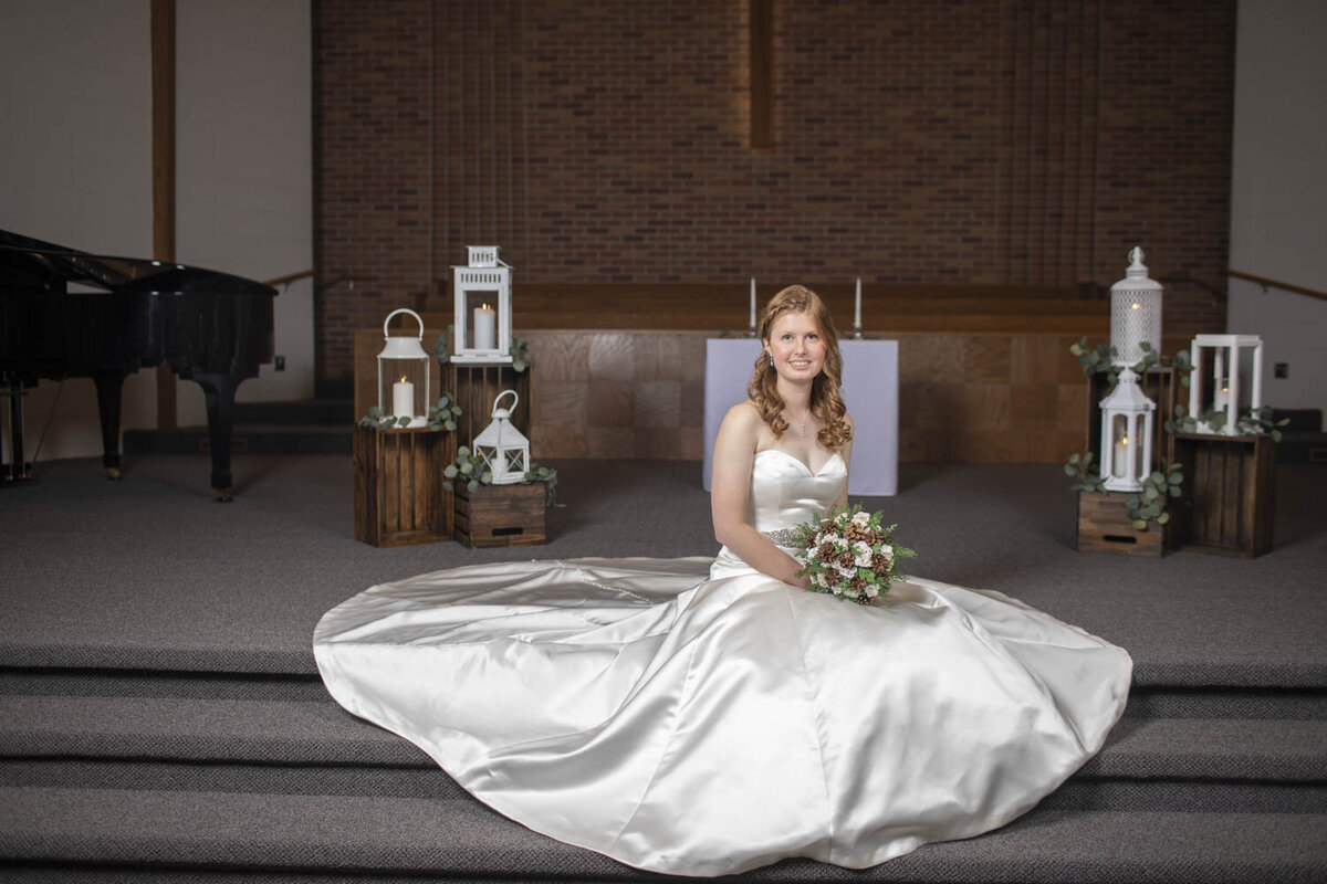 bride sits on the alter