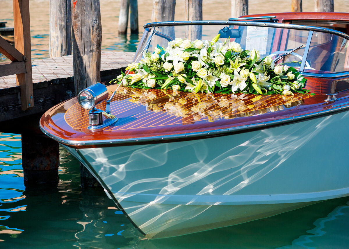 An Italian motor boat, decorated with flowers for a wedding or proposal in Venice.