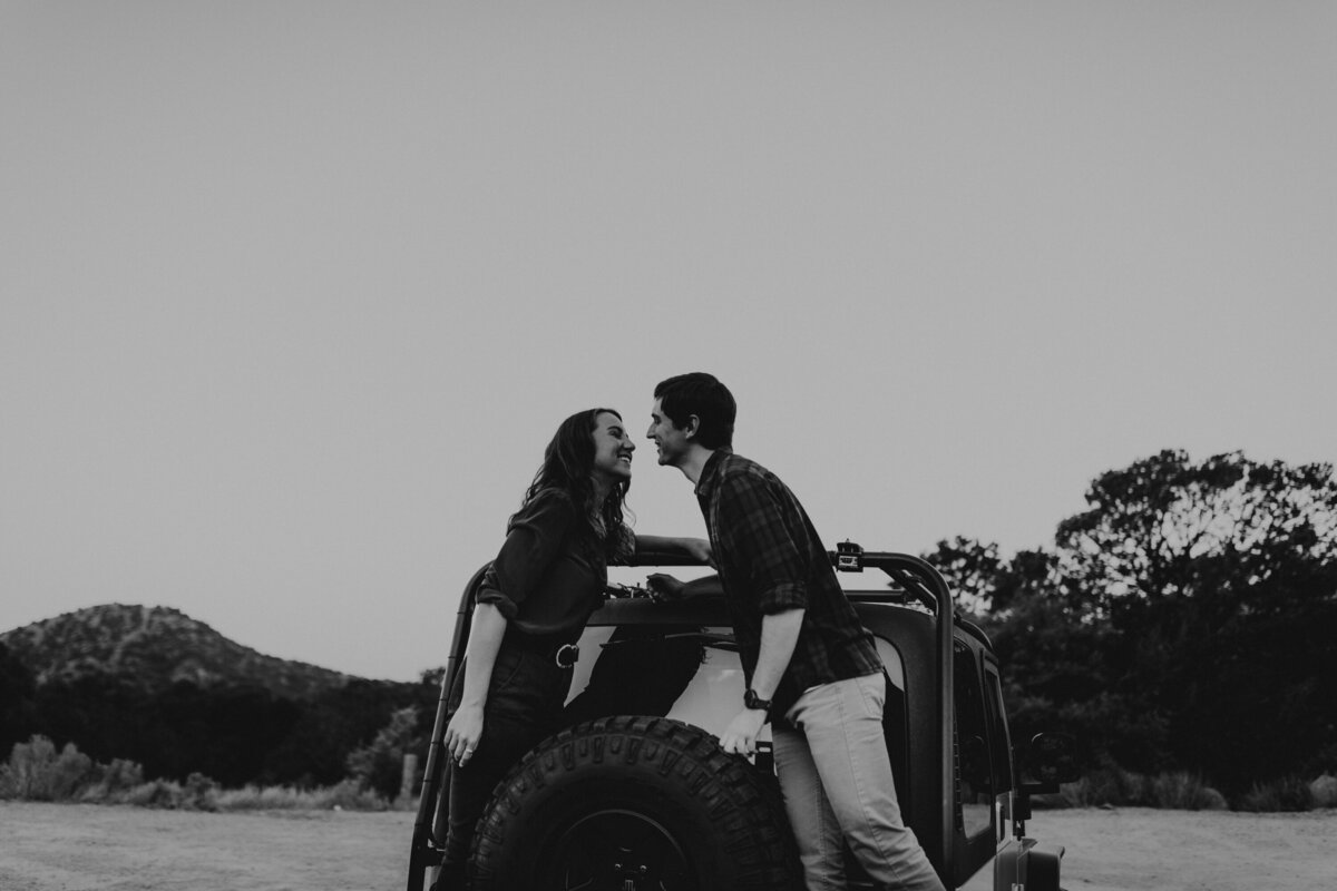 engaged couple with their jeep at the foothills in Albuquerque New Mexico