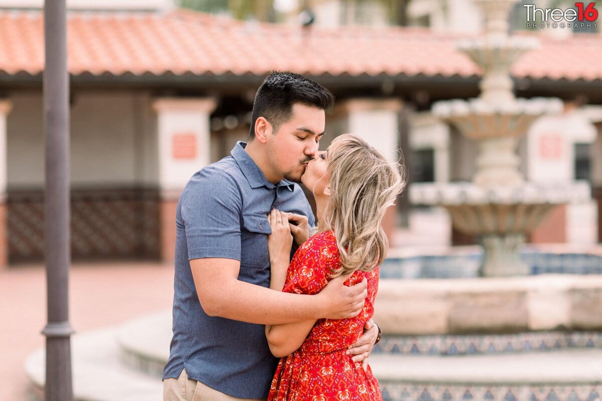 Engaged couple share a romantic kiss at the Santa Ana Train Station
