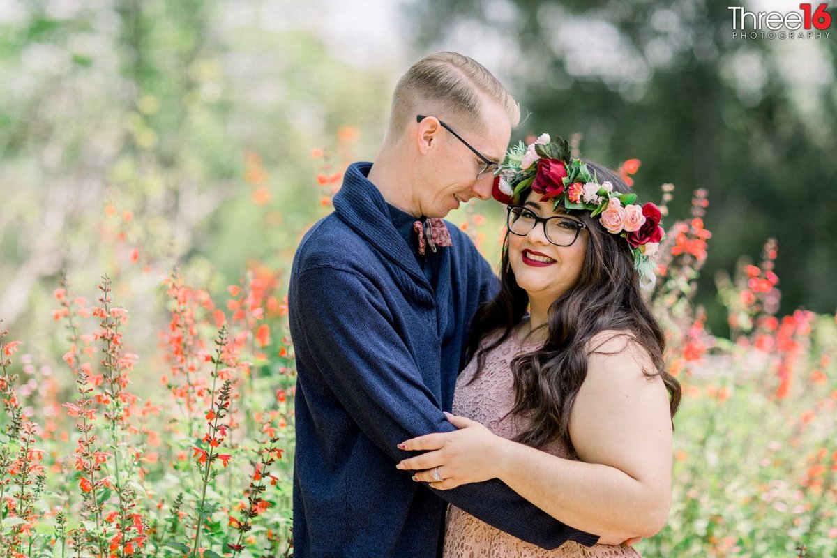 Engaged couple embrace each other as the Groom to be looks at his Bride