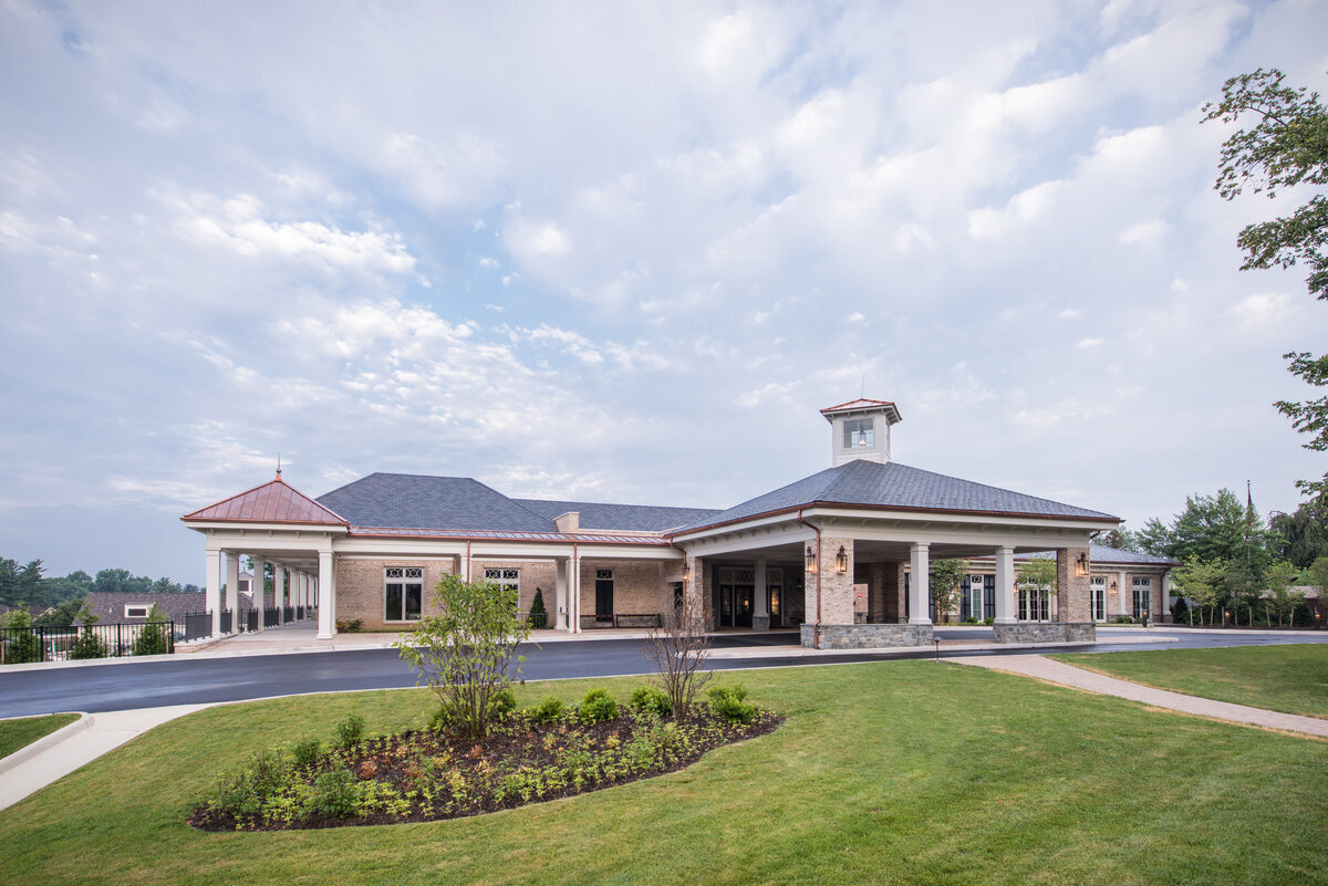 front of the clubhouse with porte cochere at Woodmont Country Club