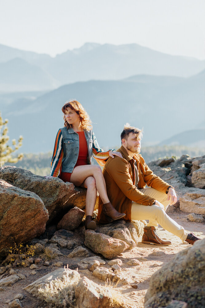 An engaged couple poses for a photo in front of Longs Peak in Estes Park, Colorado