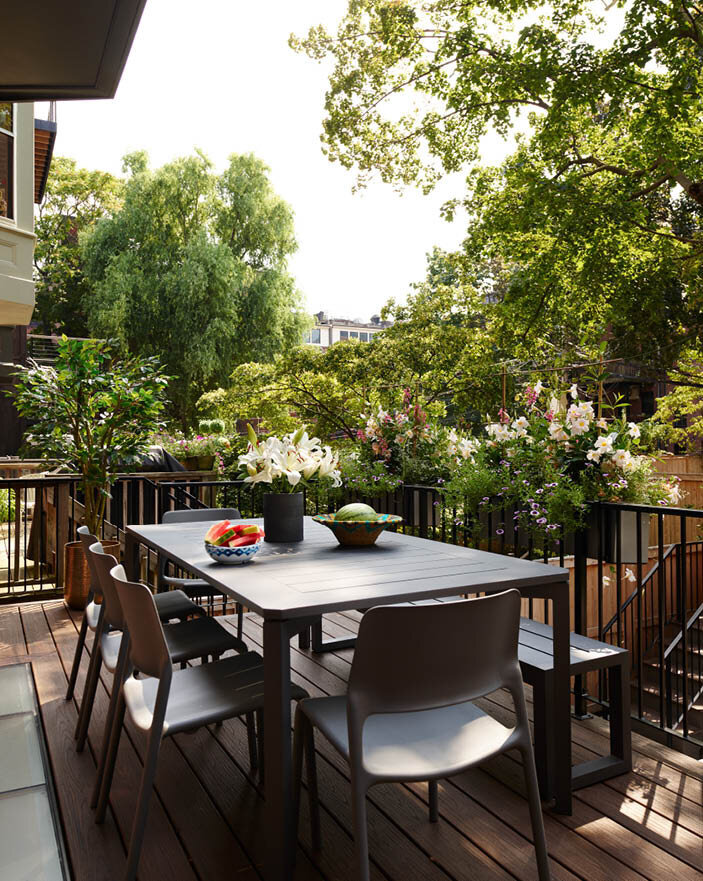 A new deck off the kitchen with glass panels that let sunlight reach the basement bedroom. Perfect for casual dining. Featured in Boston Home Magazine.