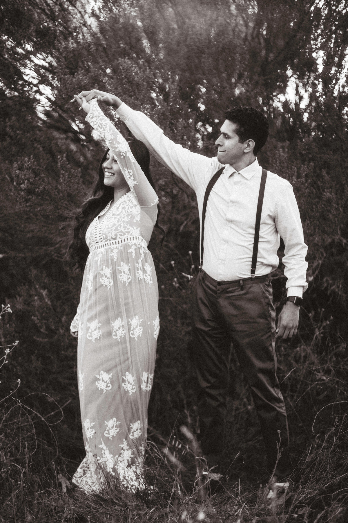 Engagement Photograph Of  Woman Taking a  Twirl Beside Man  Black And White Los Angeles