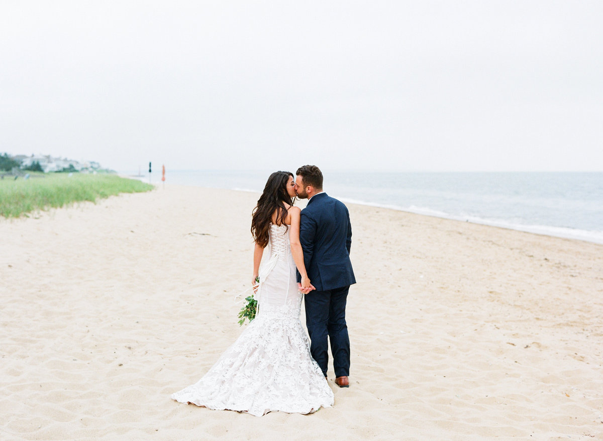 Bride and groom on beach Popponessett