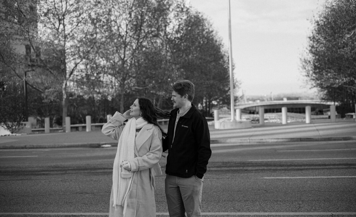 A couple looks to their left in a black and white photo.