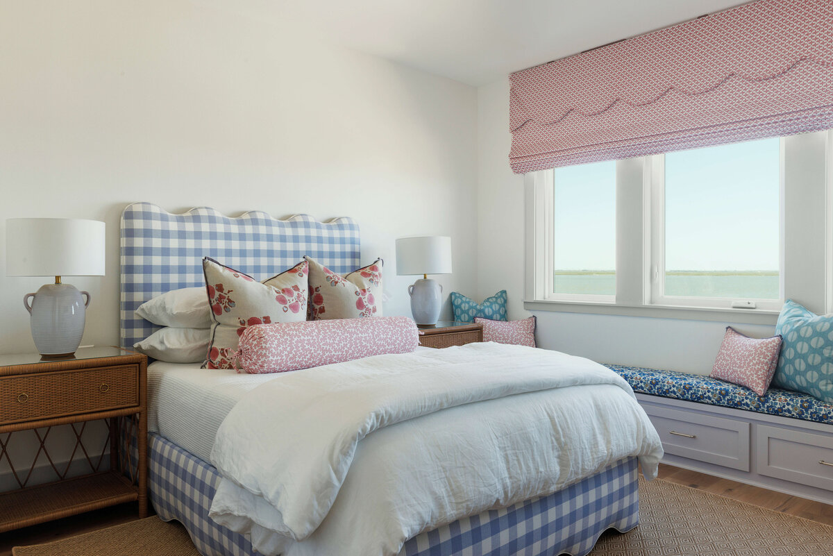oyster creek studios lighthouse on the lake blue gingham bed frame with white bedding and pink curtains in bedroom